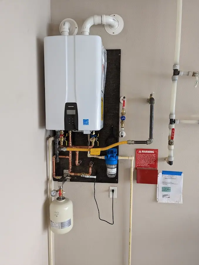 Professional plumber installing copper piping in a Bradford home